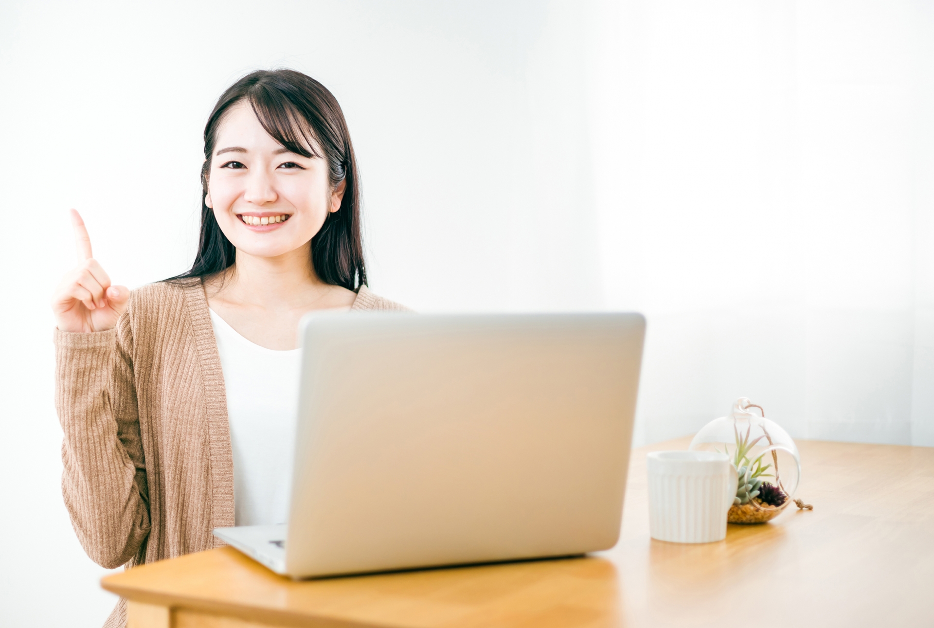 人差し指を立て笑顔を見せる女性