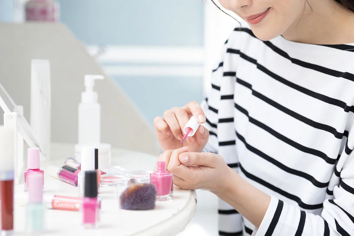 ネイリストがネイルプッシャーを使用しお客様に施術している様子